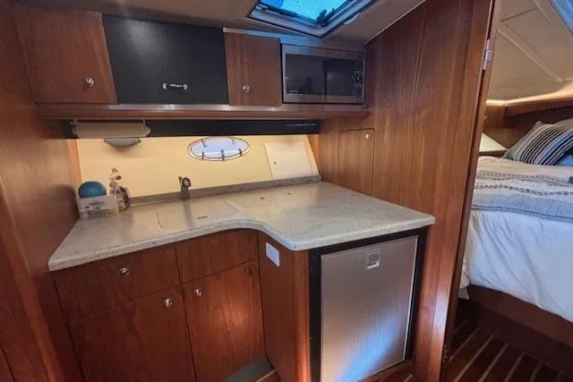 The Riddler Yacht Photos Pics 2009 Tiara Yachts 3600 Open interior with kitchenette and cozy cabin.