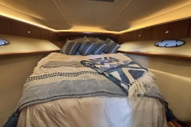 The Riddler Yacht Photos Pics Cozy cabin interior of 2009 Tiara Yachts 3600 Open with plush bedding and ambient lighting.