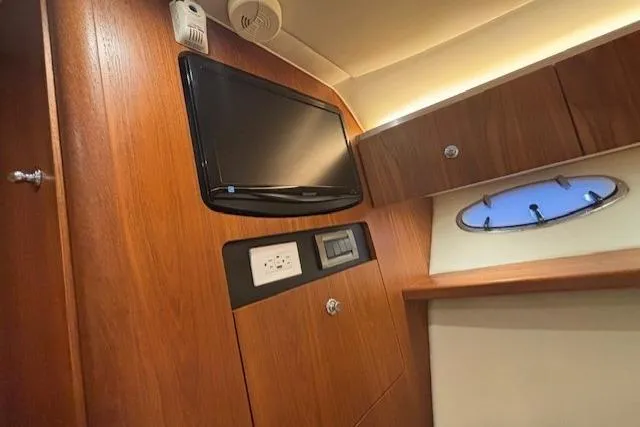 The Riddler Yacht Photos Pics 2009 Tiara Yachts 3600 Open cabin interior with TV and wooden cabinetry.