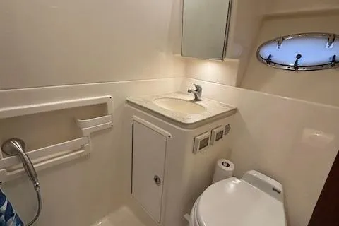 The Riddler Yacht Photos Pics 2009 Tiara Yachts 3600 Open bathroom with sink, toilet, and porthole window.