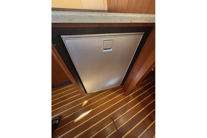 The Riddler Yacht Photos Pics 2009 Tiara Yachts 3600 Open interior with stainless steel appliance and wooden flooring.