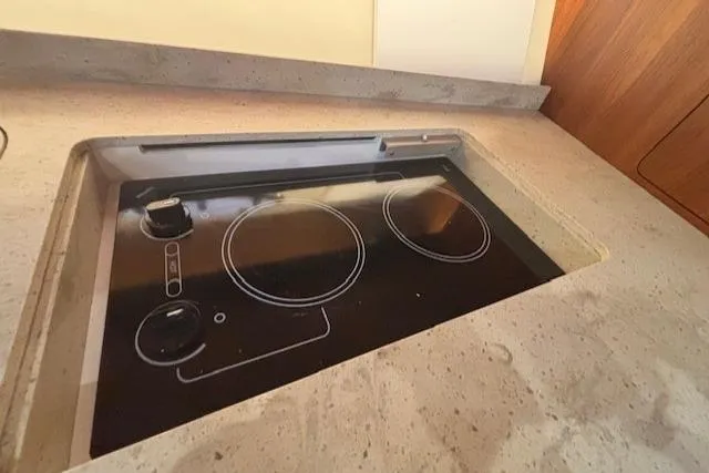 The Riddler Yacht Photos Pics Built-in stovetop on 2009 Tiara Yachts 3600 Open, featuring sleek design and modern controls.