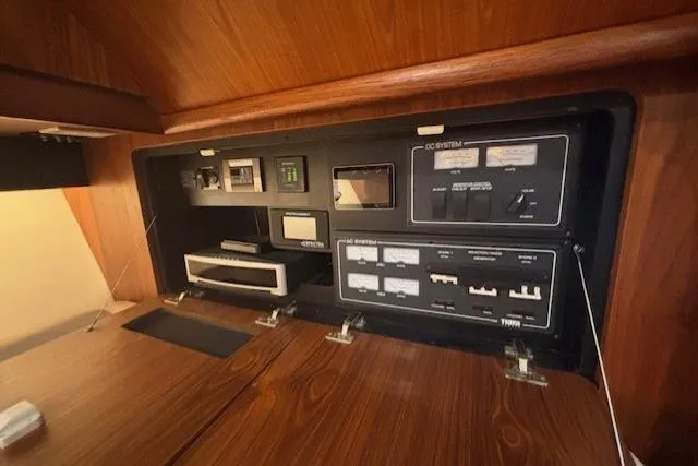 The Riddler Yacht Photos Pics 2009 Tiara Yachts 3600 Open electrical control panel in wooden interior.