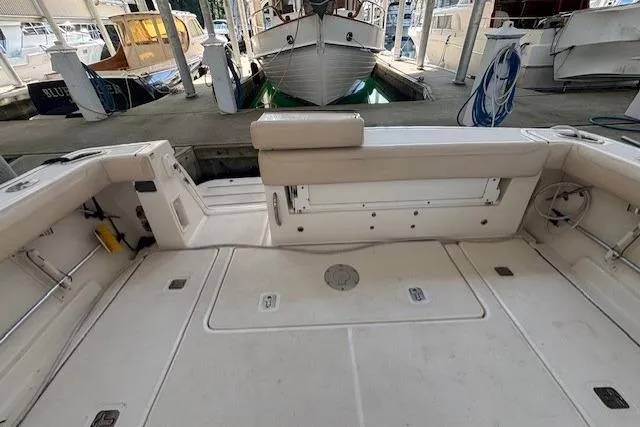 The Riddler Yacht Photos Pics 2009 Tiara Yachts 3600 Open boat deck with seating in a marina setting.