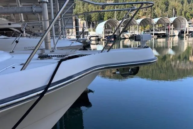 The Riddler Yacht Photos Pics 2009 Tiara Yachts 3600 Open docked in a serene marina setting.