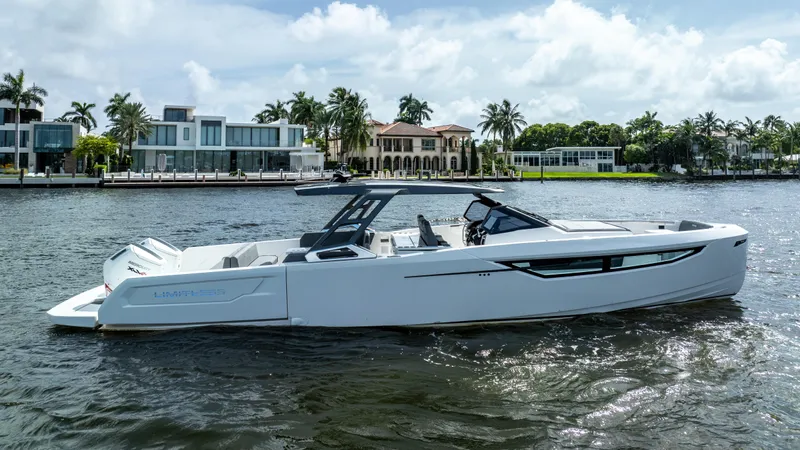  Yacht Photos Pics 2025 Limitless Seas XLV 45 yacht on a scenic waterfront with luxury homes.
