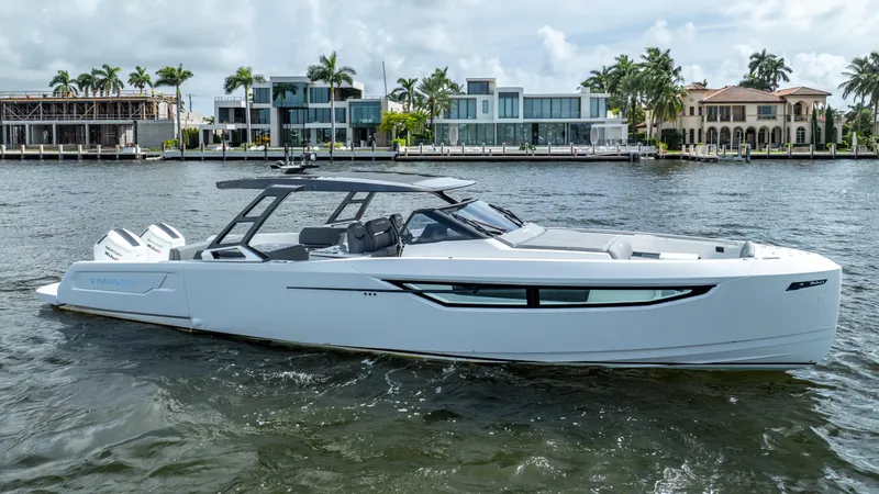  Yacht Photos Pics 2025 Limitless Seas XLV 45 yacht cruising near luxury waterfront homes.