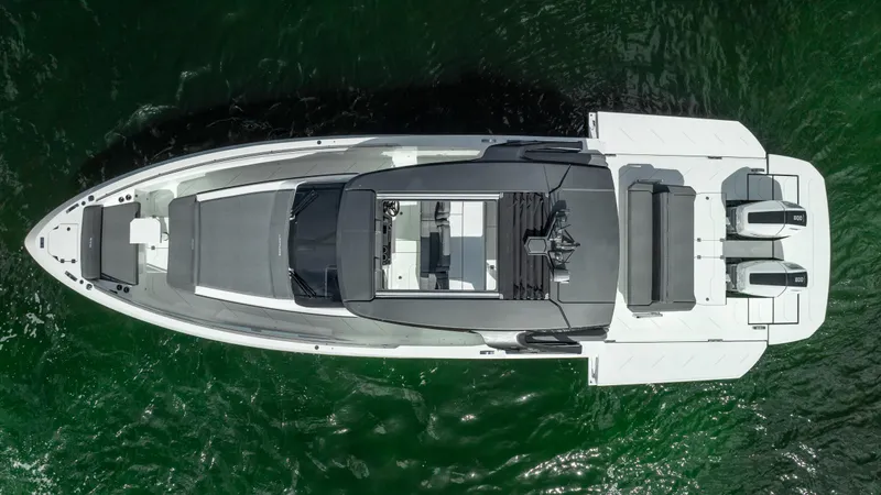  Yacht Photos Pics Aerial view of 2025 Limitless Seas XLV 45 luxury yacht on green water.