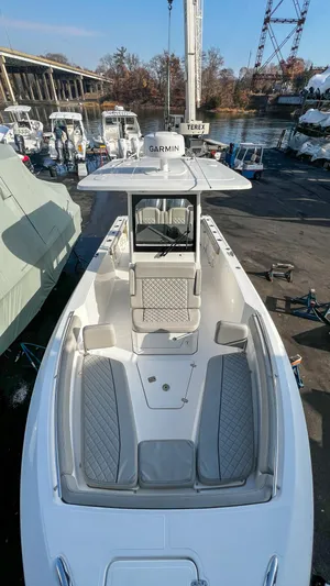  Yacht Photos Pics 2022 Pursuit S 268 boat docked, featuring spacious seating and modern design.