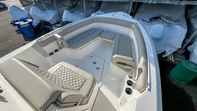  Yacht Photos Pics 2022 Pursuit S 268 boat interior with cushioned seating and storage compartments.