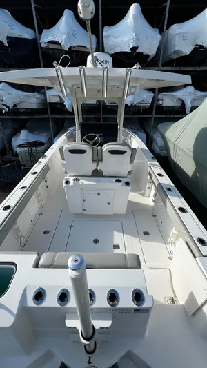  Yacht Photos Pics 2022 Pursuit S 268 boat interior with seating and storage, docked in a marina.