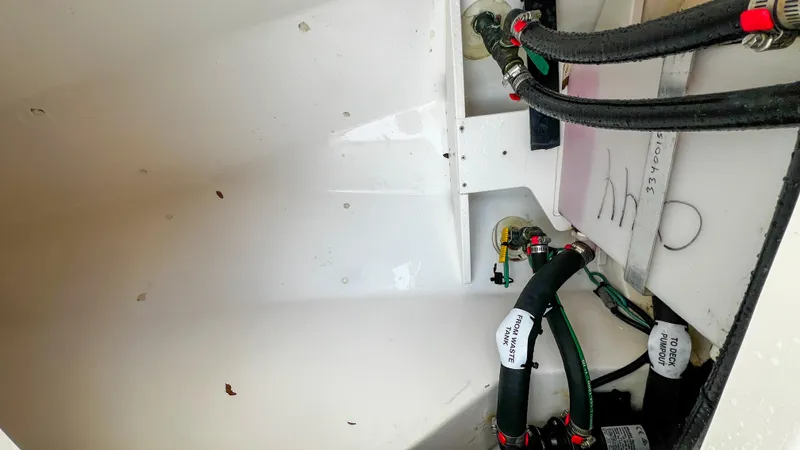  Yacht Photos Pics Interior view of 2022 Pursuit S 268 boat showing plumbing and wiring components.