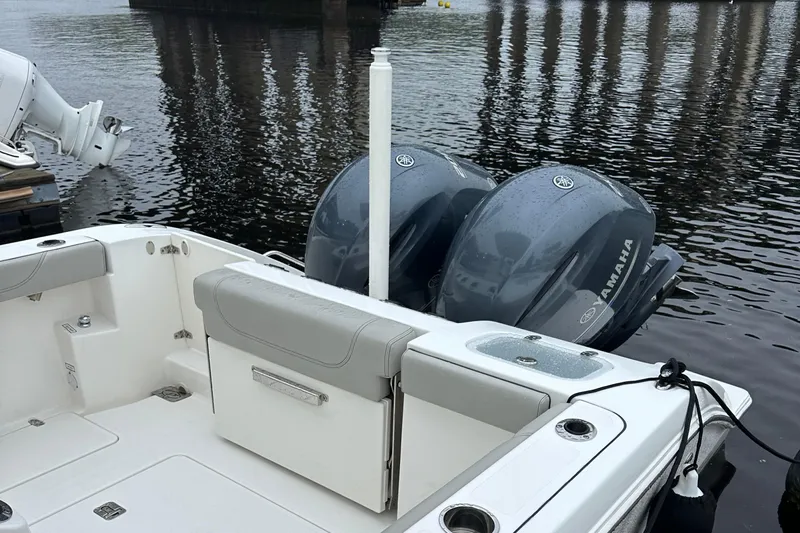  Yacht Photos Pics 2022 Pursuit S 268 boat with dual Yamaha engines, docked on calm water.