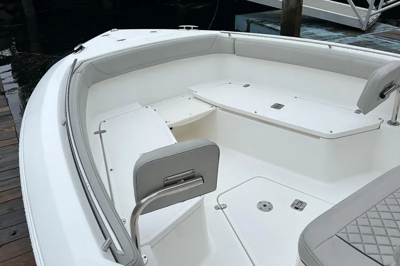  Yacht Photos Pics 2022 Pursuit S 268 boat interior with white seating and storage compartments.