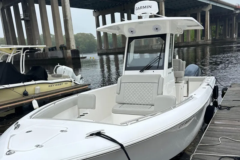  Yacht Photos Pics 2022 Pursuit S 268 boat docked by a bridge, featuring Garmin equipment.