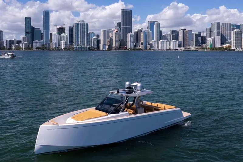 Seaduction Yacht Photos Pics 2023 Pardo Yachts 43 cruising near a city skyline on a sunny day.