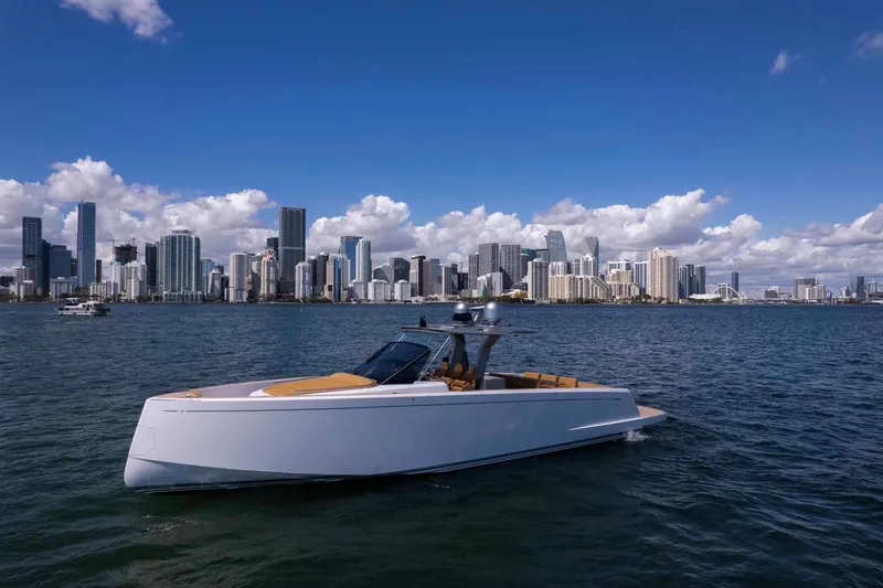 Seaduction Yacht Photos Pics 2023 Pardo Yachts 43 cruising near a city skyline under a clear blue sky.