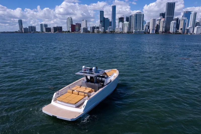 Seaduction Yacht Photos Pics 2023 Pardo Yachts 43 cruising near a city skyline on a sunny day.