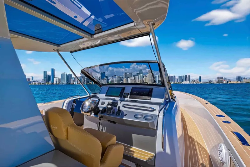 Seaduction Yacht Photos Pics 2023 Pardo Yachts 43 cockpit with city skyline view, featuring modern navigation equipment.