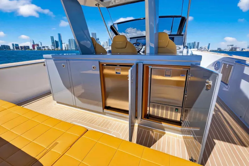 Seaduction Yacht Photos Pics Luxurious 2023 Pardo Yachts 43 interior with city skyline view, featuring sleek cabinetry and seating.