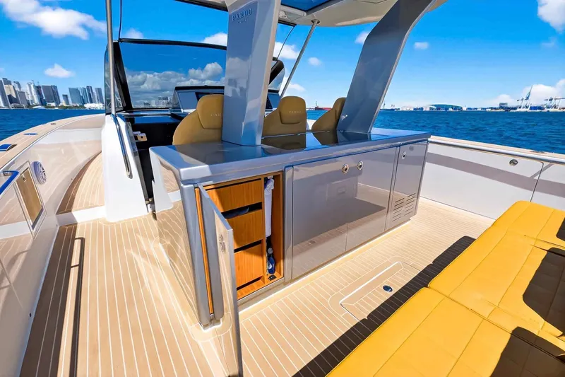 Seaduction Yacht Photos Pics Luxurious 2023 Pardo Yachts 43 with sleek deck and modern seating, city skyline backdrop.