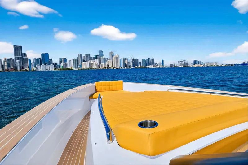 Seaduction Yacht Photos Pics 2023 Pardo Yachts 43 with yellow deck, city skyline in background.