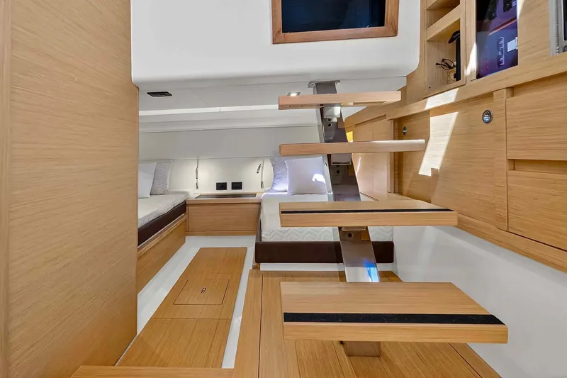 Seaduction Yacht Photos Pics Modern interior of 2023 Pardo Yachts 43, featuring sleek wooden design and cozy sleeping area.
