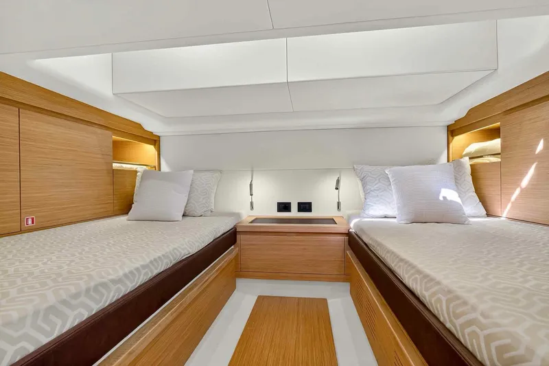 Seaduction Yacht Photos Pics Luxurious interior of 2023 Pardo Yachts 43 with twin beds and modern wood finish.