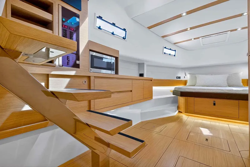 Seaduction Yacht Photos Pics Luxurious interior of 2023 Pardo Yachts 43, featuring modern wood finishes and cozy sleeping area.