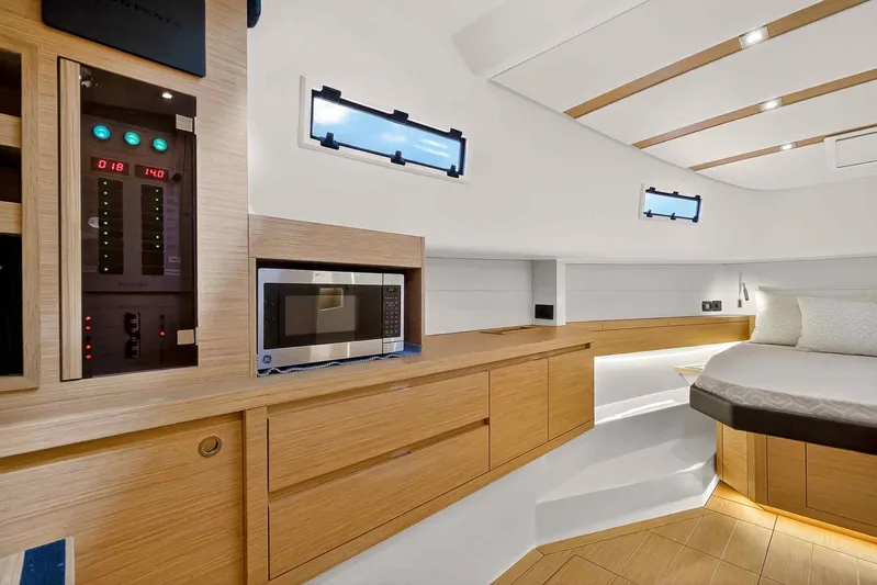 Seaduction Yacht Photos Pics Luxurious interior of 2023 Pardo Yachts 43 with modern amenities and elegant wood finish.