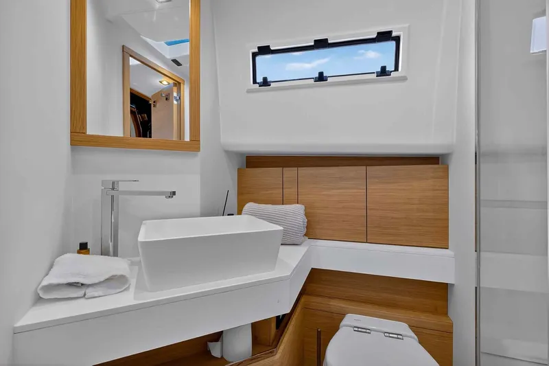 Seaduction Yacht Photos Pics Luxurious bathroom interior of 2023 Pardo Yachts 43, featuring modern sink and wooden accents.