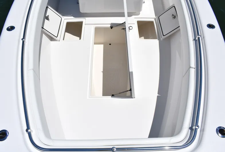 Yacht Photos Pics 2024 Contender 28 Tournament boat deck with open storage compartments.