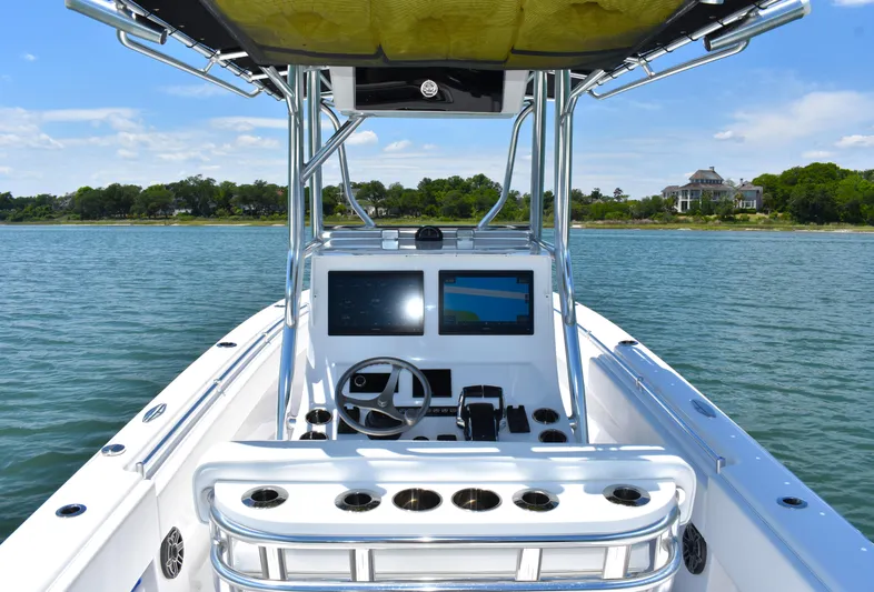  Yacht Photos Pics 2024 Contender 28 Tournament boat dashboard with dual screens on calm water.