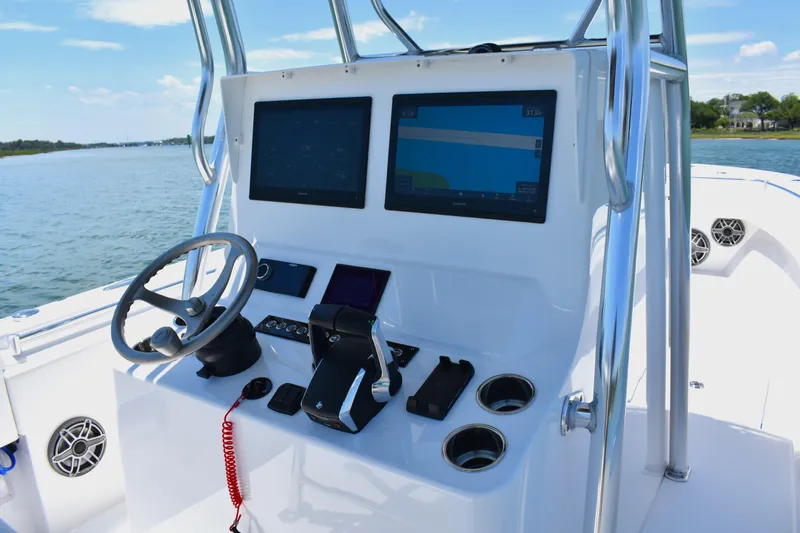  Yacht Photos Pics 2024 Contender 28 Tournament boat console with dual screens and steering wheel on open water.
