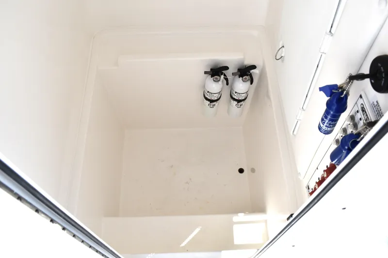  Yacht Photos Pics 2024 Contender 28 Tournament storage compartment with fire extinguishers and equipment.