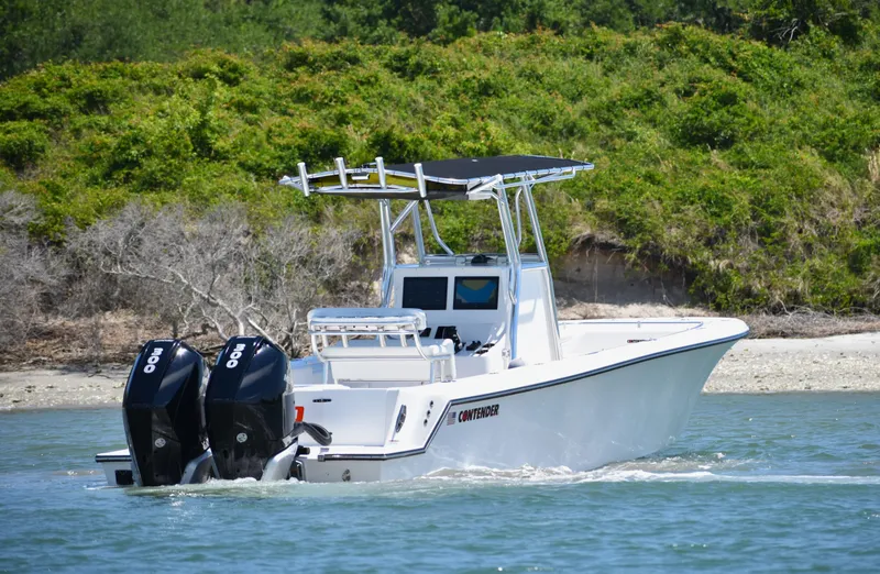  Yacht Photos Pics 2024 Contender 28 Tournament boat cruising on water with twin outboard engines.