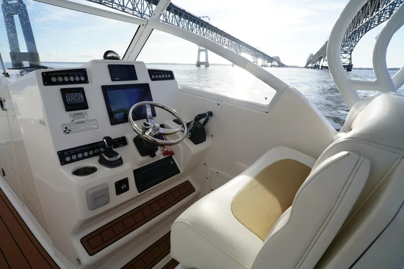 Yacht Photos Pics Helm of 2016 Edgewater 280 CX boat with bridge view in background.