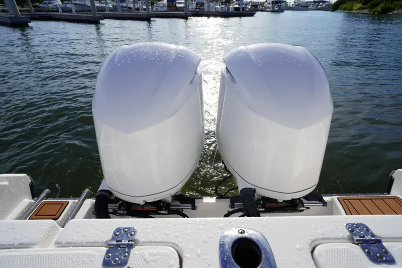  Yacht Photos Pics Twin outboard engines on a 2016 Edgewater 280 CX boat at a marina.