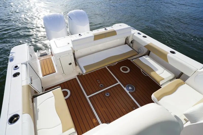  Yacht Photos Pics 2016 Edgewater 280 CX boat interior with teak flooring and cushioned seating.