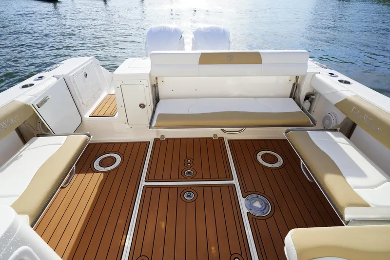  Yacht Photos Pics 2016 Edgewater 280 CX boat interior with teak flooring and cushioned seating.