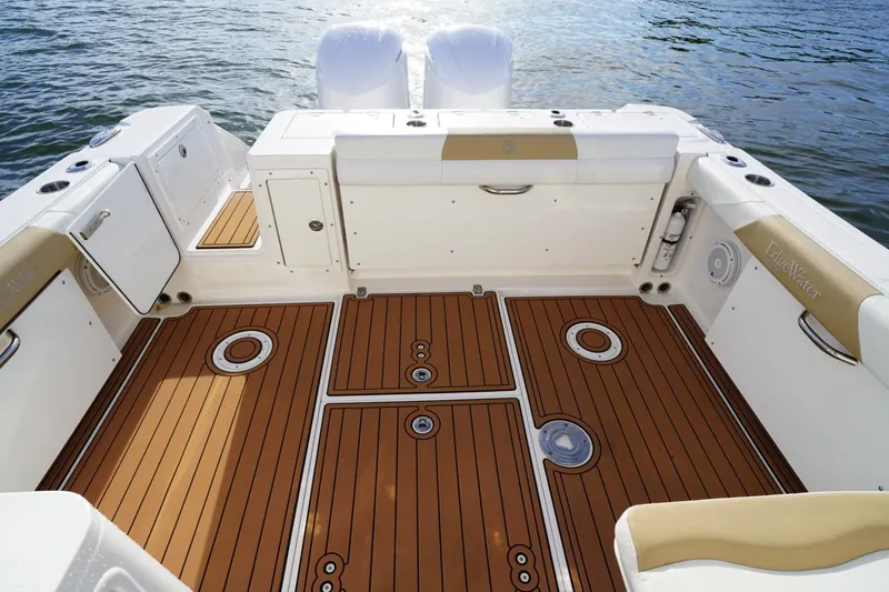  Yacht Photos Pics 2016 Edgewater 280 CX boat interior with teak flooring and white seating, on water.