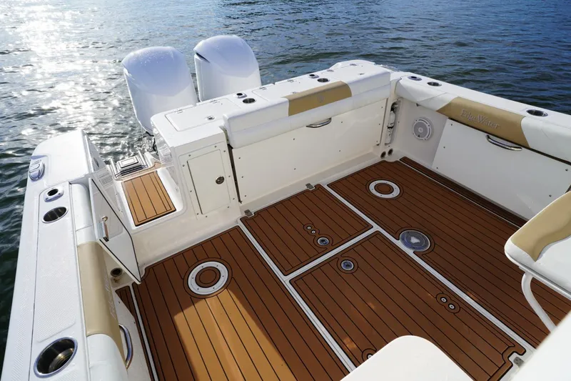  Yacht Photos Pics 2016 Edgewater 280 CX boat deck with teak flooring and dual engines on water.