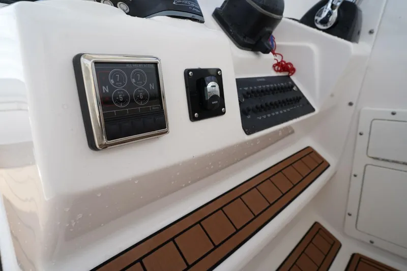  Yacht Photos Pics Control panel of a 2016 Edgewater 280 CX boat with digital display and switches.