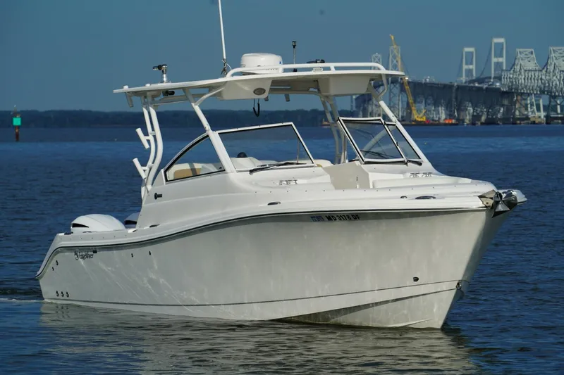  Yacht Photos Pics 2016 Edgewater 280 CX boat cruising on water near a bridge.