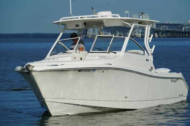  Yacht Photos Pics 2016 Edgewater 280 CX boat cruising on calm waters near a bridge.