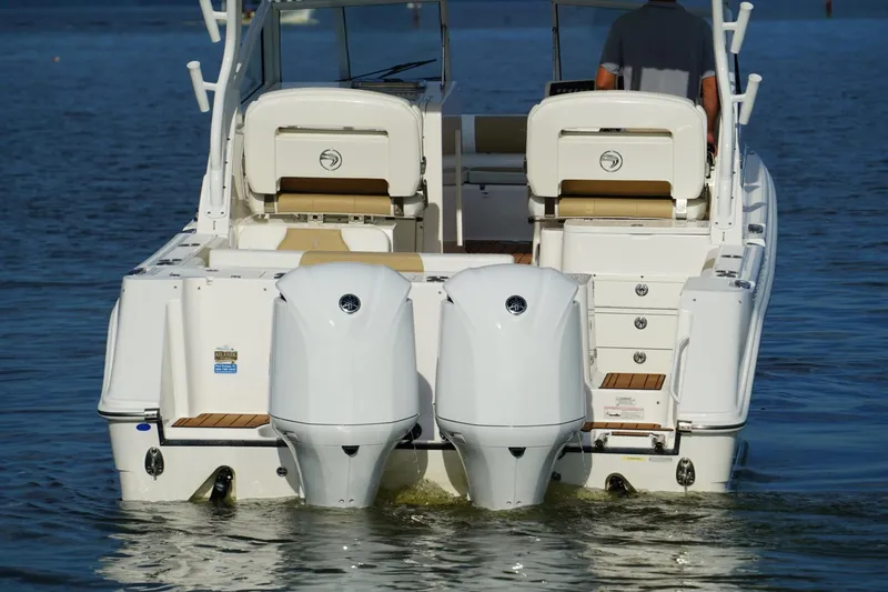  Yacht Photos Pics 2016 Edgewater 280 CX boat with dual outboard engines on water.