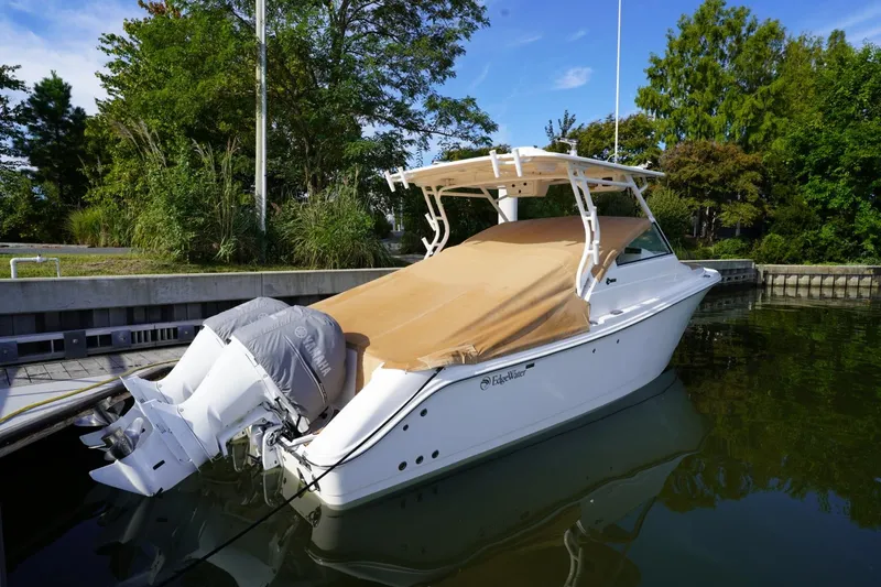  Yacht Photos Pics 2016 Edgewater 280 CX boat docked, covered, with Yamaha engines, surrounded by greenery.