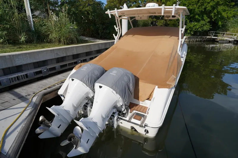  Yacht Photos Pics 2016 Edgewater 280 CX boat with twin Yamaha outboard engines docked by the water.