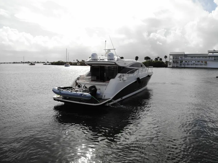 For Whom The Bell Tolls Yacht Photos Pics 2017 Sea Ray L590 yacht on calm water under cloudy sky.
