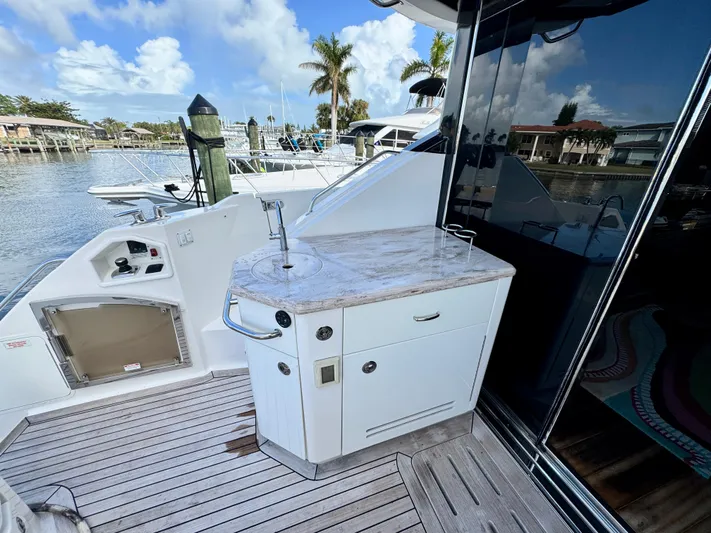 For Whom The Bell Tolls Yacht Photos Pics 2017 Sea Ray L590 yacht deck with outdoor kitchenette and marina view.